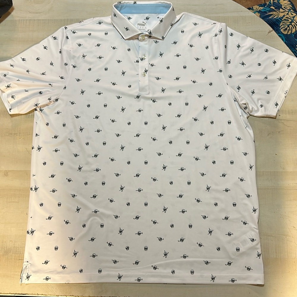 Puma golf polo white with skull and putter. This is a polyester elastine blend